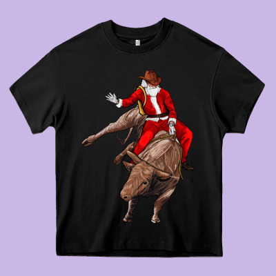 Santa Riding A Bull Heavy Core Tee Designed By Cowgirlartshop