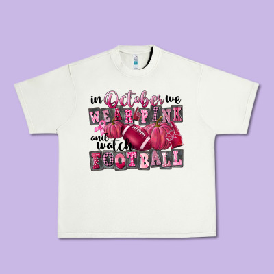 In October We Wear Pink And Watch Football Urban Heavy Tee Designed By Fadigitalartstudio