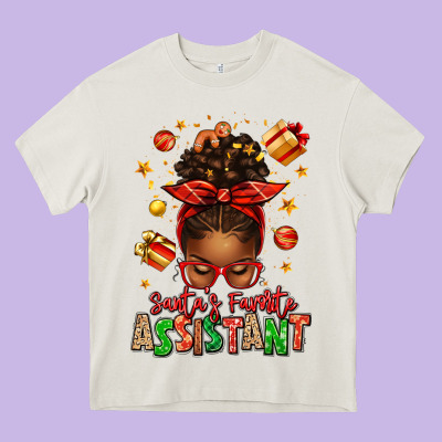 Santa's Favorite Assistant Afro Messy Bun Heavy Core Tee Designed By Texasbilliewilder