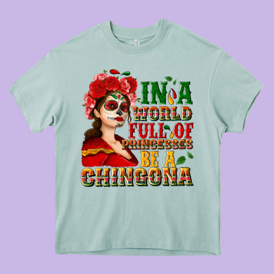 In A World Full Of Princesses Be A Chingona Heavy Core Tee Designed By Nancycooperartshop