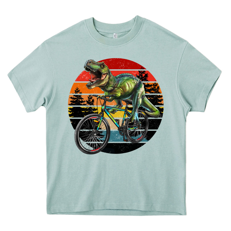 T Rex Dinosaur Riding Bicycle With Retro Forest Sunset Heavy Core Tee by RanaPortraitStore | Teevron