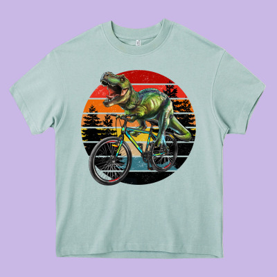 T Rex Dinosaur Riding Bicycle With Retro Forest Sunset Heavy Core Tee Designed By Ranaportraitstore