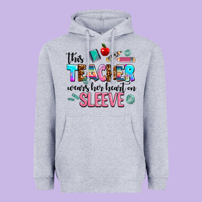 This Teacher Wears Her Heart On Sleeve Heavyweight Hoodie Designed By Adodesignshop