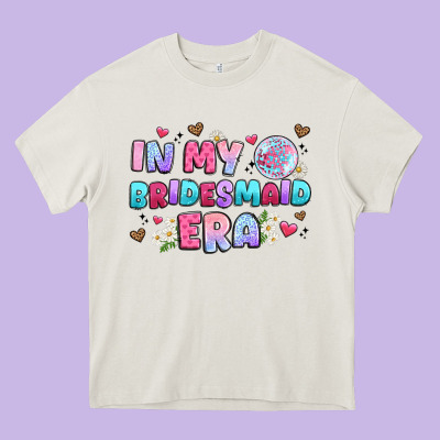 In My Bridesmaid Era Heavy Core Tee Designed By Artiststas