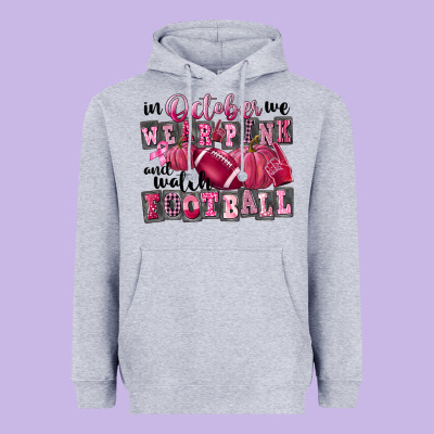 In October We Wear Pink And Watch Football Heavyweight Hoodie Designed By Fadigitalartstudio