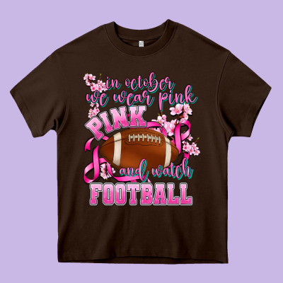 In October We Wear Pink And Watch Football Heavy Core Tee Designed By Adodesignshop