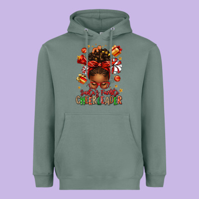 Santa's Favorite Cheerleader Afro Messy Bun Heavyweight Hoodie Designed By Texasbilliewilder
