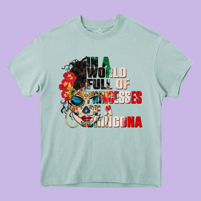 In A World Full Of Princesses Be A Chingona Heavy Core Tee Designed By Cts Tumbler Store