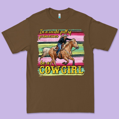 In A World Full Of Princesses Be A Cowgirl Premium Tee Designed By Ranaportraitstore