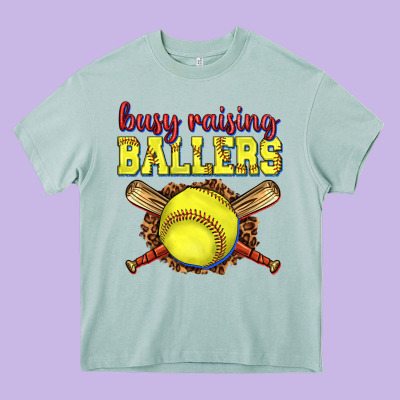 Busy Raising Ballers Softball Heavy Core Tee Designed By Texasbilliewilder