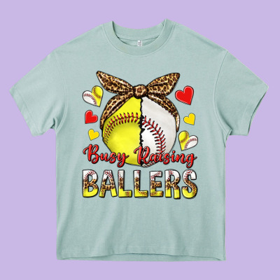 Busy Raising Ballers With Baseball And Softball Heavy Core Tee Designed By Texasbilliewilder