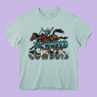 The World Needs More Cowboys Heavy Core Tee Designed By Zillion Design Studio
