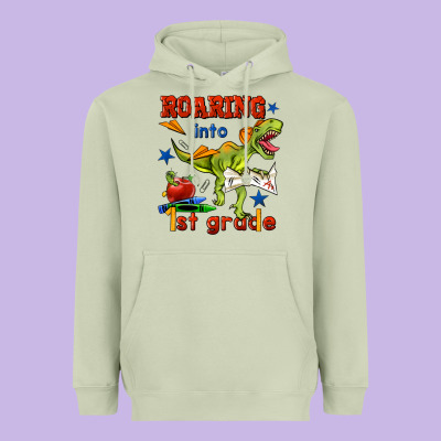 Roaring Into 1st Grade Heavyweight Hoodie Designed By Bundleandbundleshop