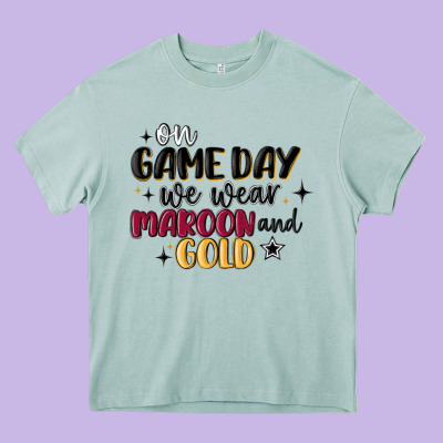 On Game Day We Wear Maroon And Gold Heavy Core Tee Designed By Maliassmallbusiness