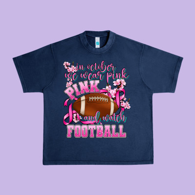 In October We Wear Pink And Watch Football Urban Heavy Tee Designed By Adodesignshop
