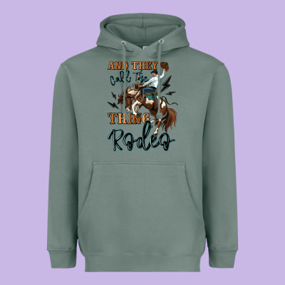 And They Call The Thing Rodeo Cowboy Heavyweight Hoodie Designed By Maliassmallbusiness