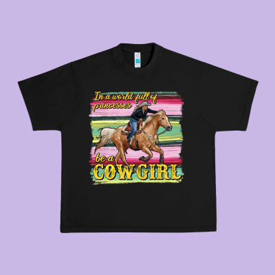 In A World Full Of Princesses Be A Cowgirl Urban Heavy Tee Designed By Ranaportraitstore