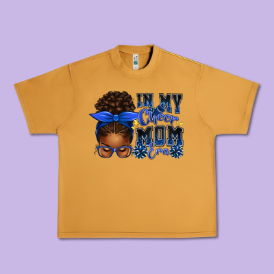 In My Cheer Mom Era Afro Messy Bun Urban Heavy Tee Designed By Texasbilliewilder
