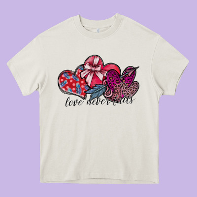 Love Never Fails Heavy Core Tee Designed By Sublimationcraftshop