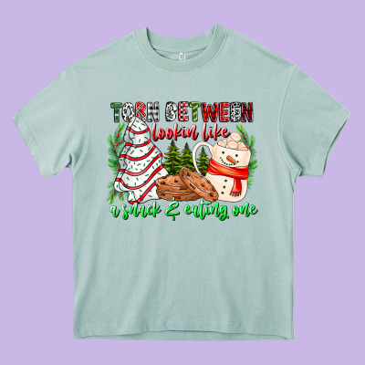 Torn Between Looking Like A Snack Eating One Heavy Core Tee Designed By Cowhidedigitalart