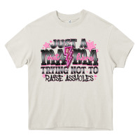 Cream Just a Mama Out Here Trying Not To Raise Assholes Heavy Core Tee - CowhideDigitalArt