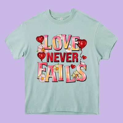 Love Never Fails Heavy Core Tee Designed By Fadigitalartstudio
