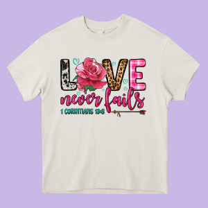 Love Never Fails Heavy Core Tee Designed By Oliviacreatesart
