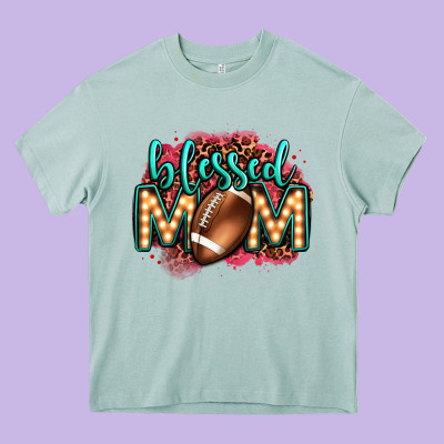 Blessed American Football Mom Lightbulb Letters Heavy Core Tee Designed By Oliviacreatesart