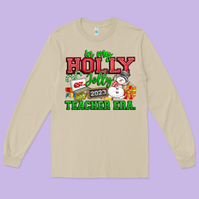 In My Holly Jolly Teacher Era Long Sleeve Tee Designed By Cowhidedigitalart